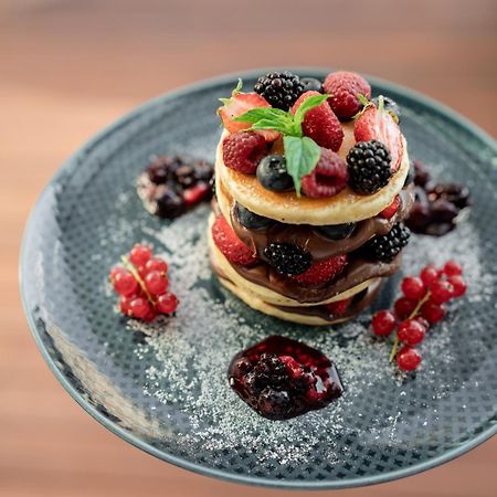 Address Istanbul Hotell Exteriör bild A stack of pancakes with fruit